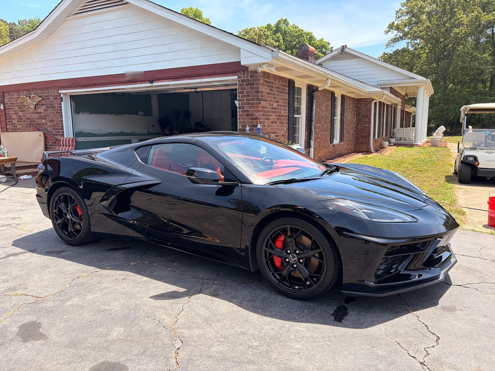Black Chevrolet Corvette detailed and parked on a driveway
