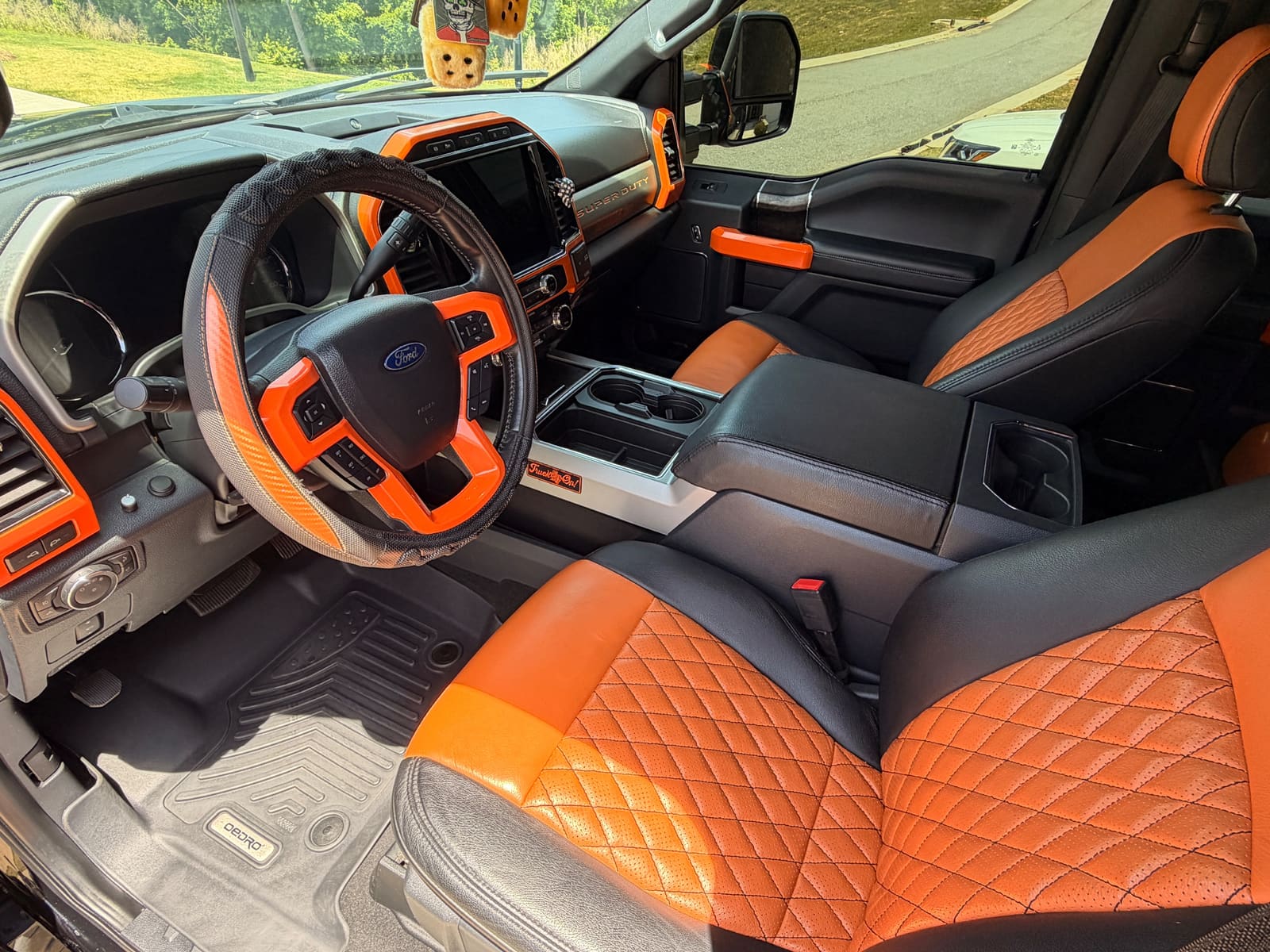 Truck interior with orange and black leather seats after an interior detail