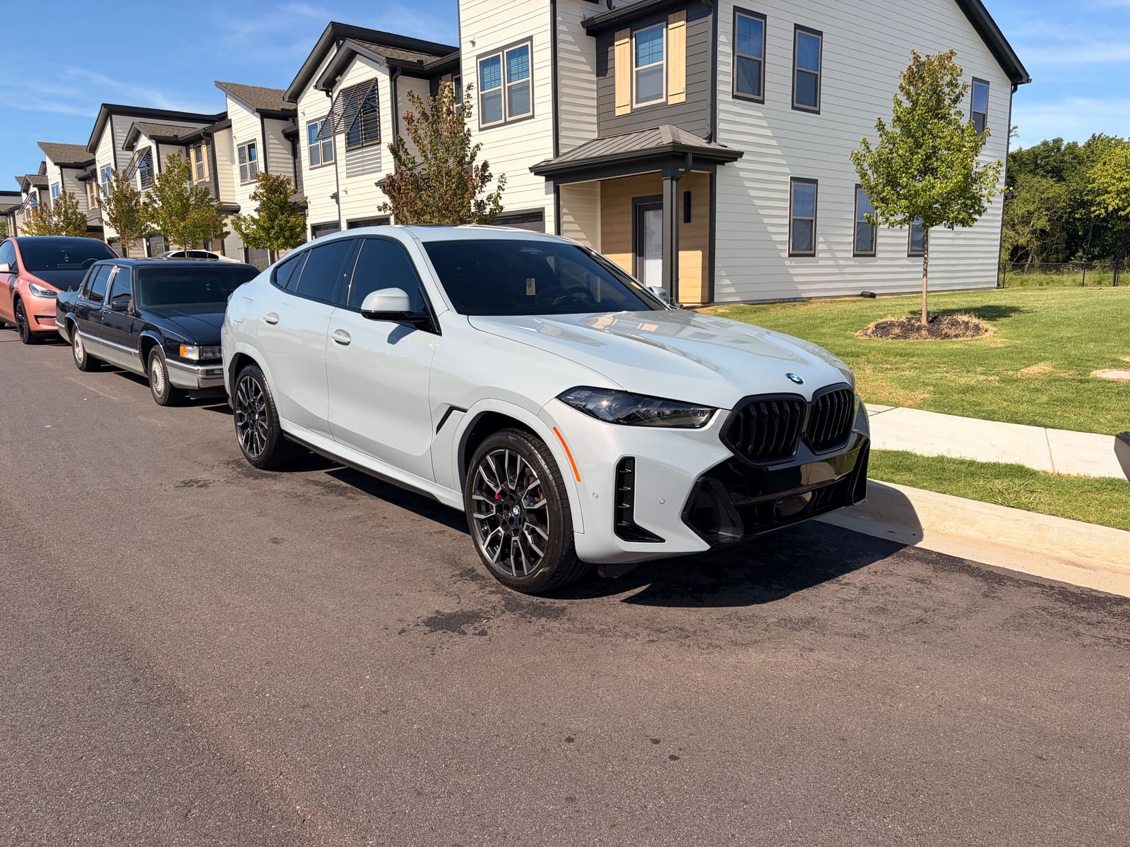 White BMW X6 detailed and parked on a residential street