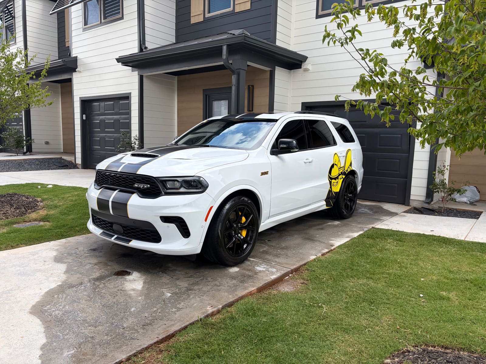 White Dodge Durango SRT with racing stripes, detailed on a driveway